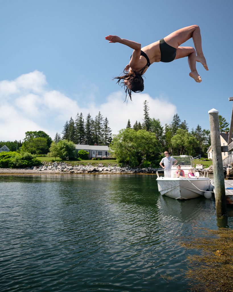 The photographer’s wife shows off for the kids, jumping into Tenants harbor, Maine.