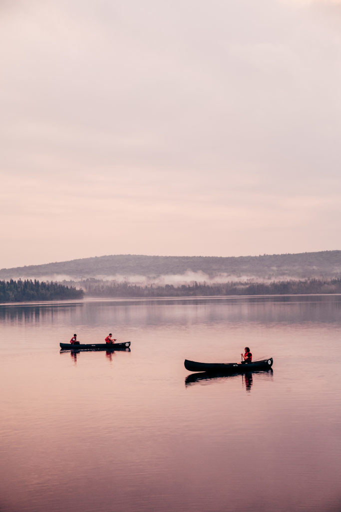 Two solitary Canoes on a lake in Maine