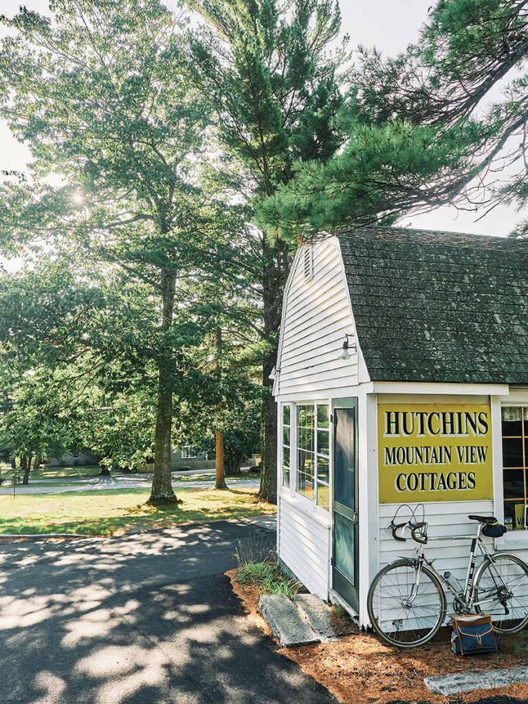 A bike leans against Hutchins Mountain View Cottages, Mount Desert Island, Maine